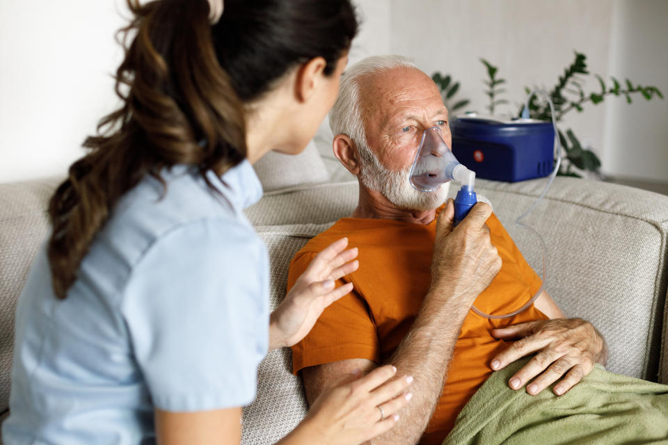 Senior Man With Chronic Bronchitis is Using Inhaler.