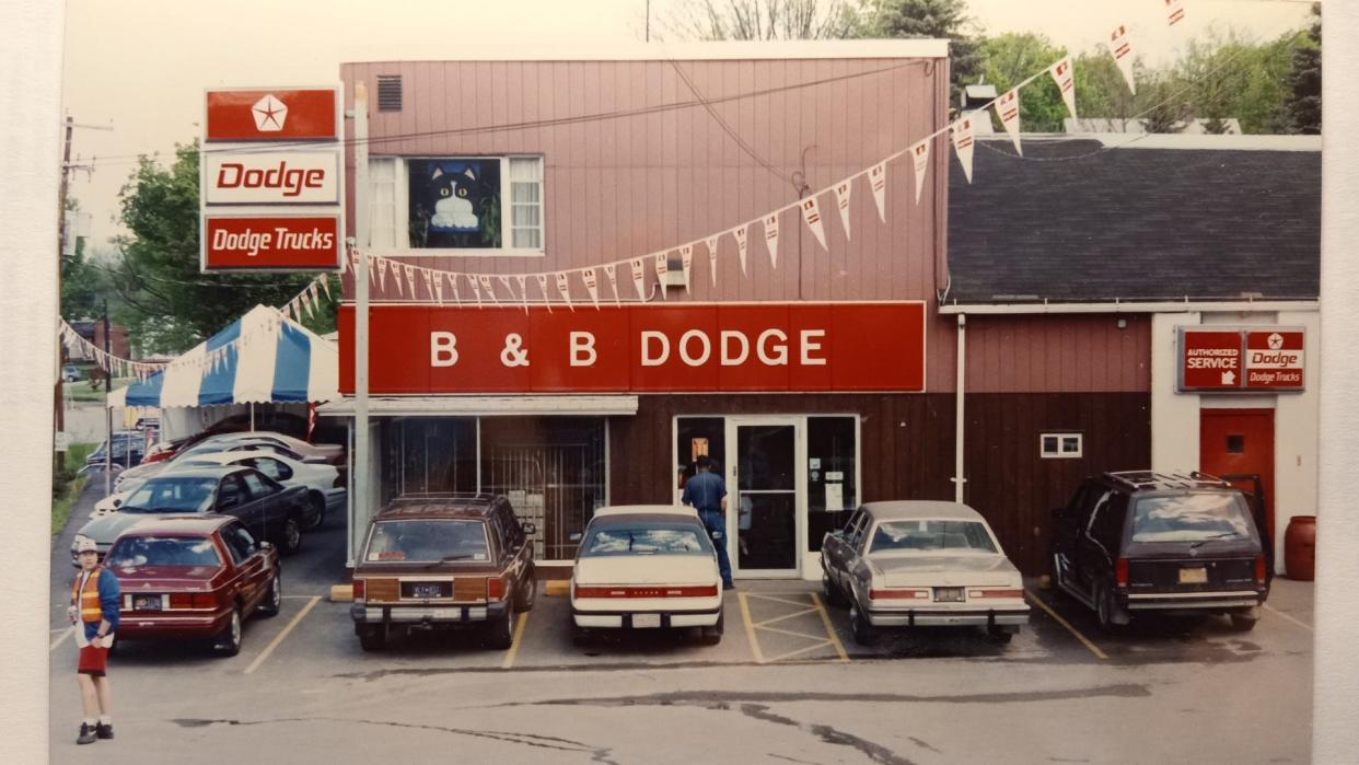 This is a photo of B&B Dodge taken in May 1995 during the company's 25th anniversary celebration. Since opening the new showroom building in 2014, the service and parts department has continued in the older building.