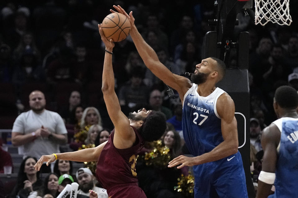 Cleveland Cavaliers center Jarrett Allen, left, is fouled by Minnesota Timberwolves center Rudy Gobert (27) in the second half of an NBA basketball game, Friday, March 8, 2024, in Cleveland. (AP Photo/Sue Ogrocki)