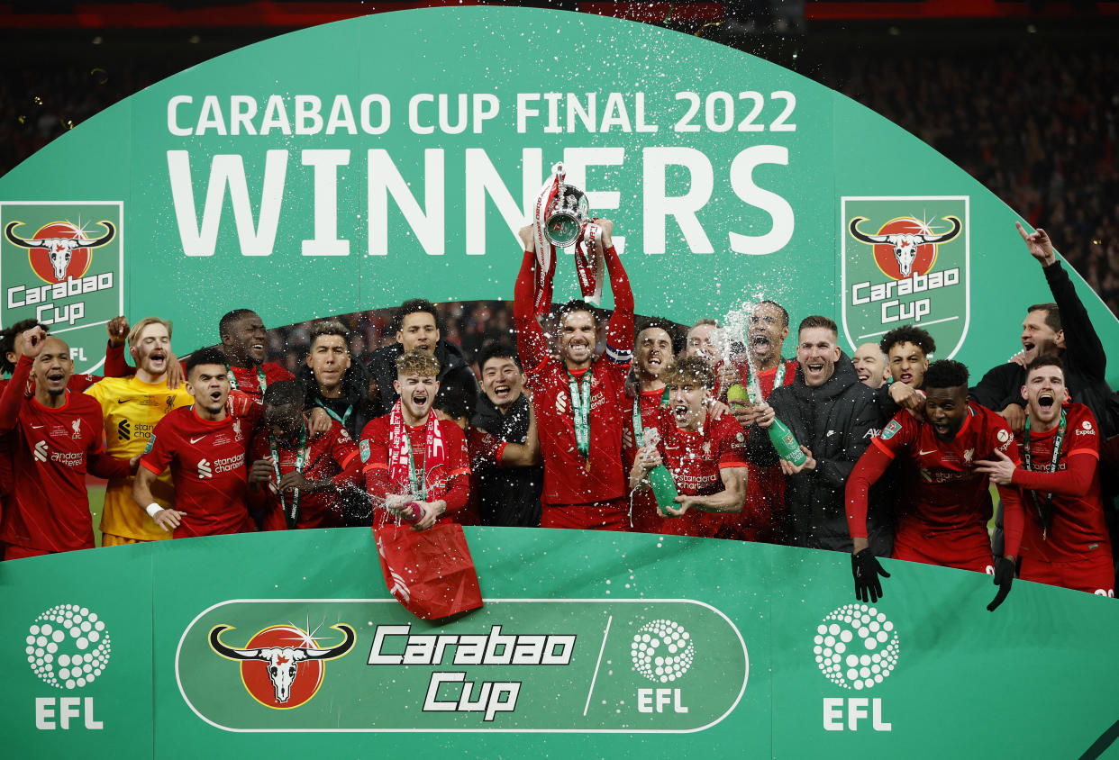 Liverpool players celebrate winning the Carabao Cup in February.