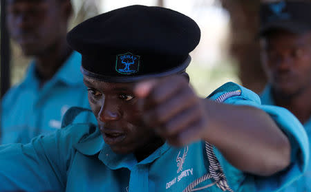 A Kenyan security guard participates in physical exercise during martial arts combat training at the Chinese-run Deway Security Group compound in Kenya's capital Nairobi, March 13, 2017. REUTERS/Thomas Mukoya