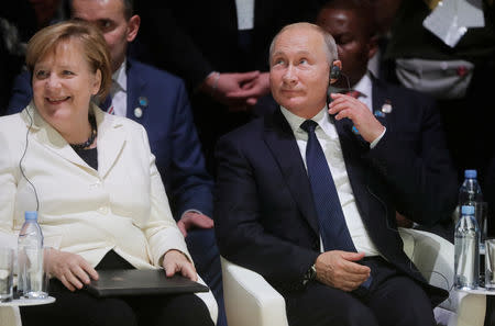 German Chancellor Angela Merkel and Russian President Vladimir Putin attend the opening session of the Paris Peace Forum as part of the commemoration ceremony for Armistice Day, 100 years after the end of the First World War, in Paris, France, November 11, 2018. Sputnik/Mikhail Metzel/Kremlin via REUTERS