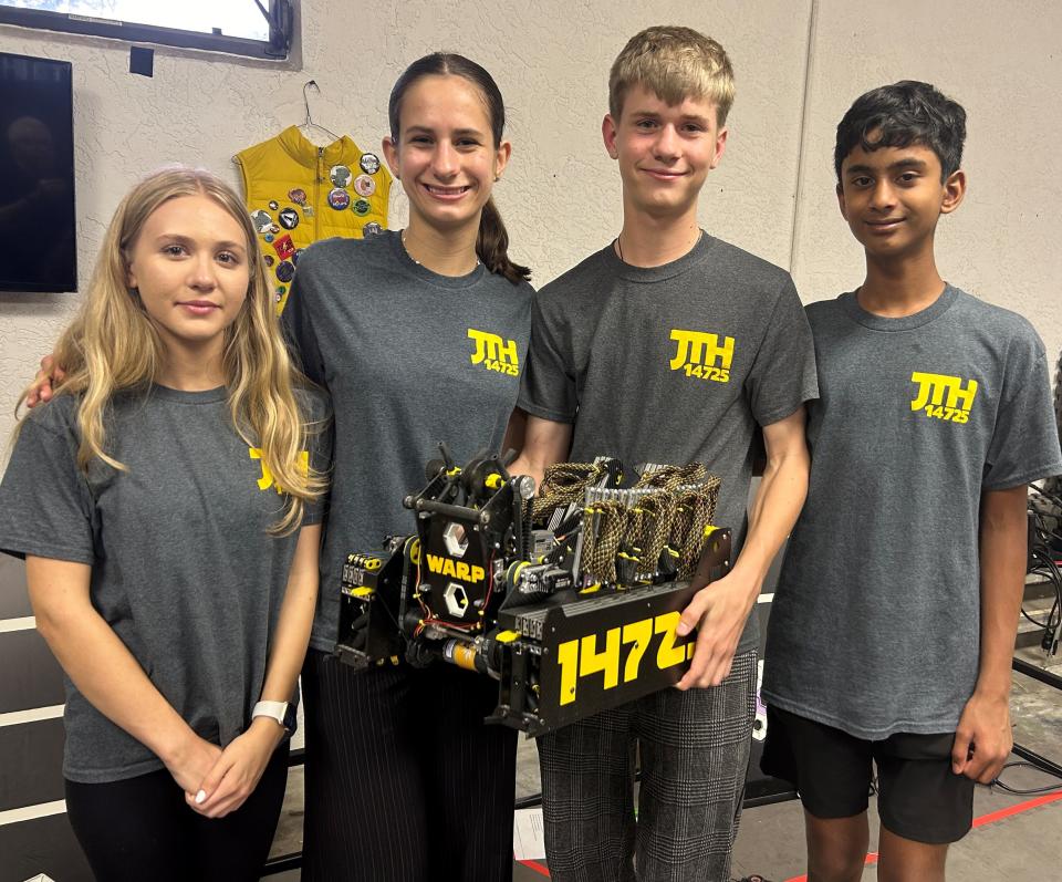 Members of the Fort Myers robotics team Java the Hutts show off their approximately 35-pound robot, WARP. Pictured, left to right, are Delaney Baucom, Almira Pratasenia, Nikolai Pratasenia and Dhira Sharma.