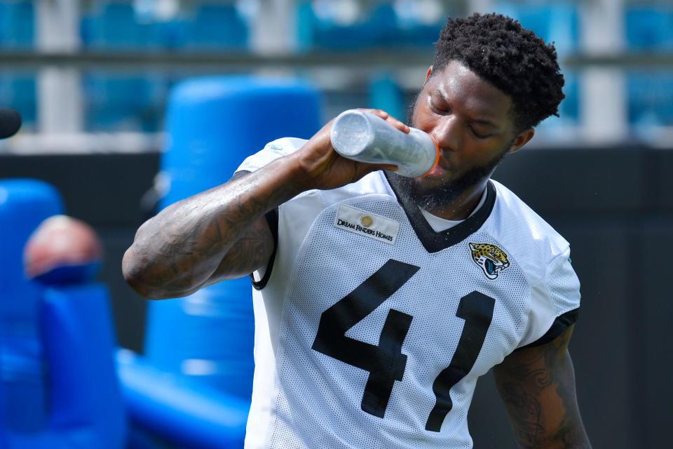 Jaguars DE (41) Josh Allen takes a water break during the Jacksonville Jaguars Organized Team Activity session at TIAA Bank Field Monday, May 23, 2022.