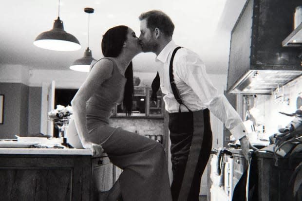 Prince Harry and Meghan Markle kiss in the kitchen of their home in a snapshot from their "Harry & Meghan" documentary series on Netflix.<p>Netflix</p>
