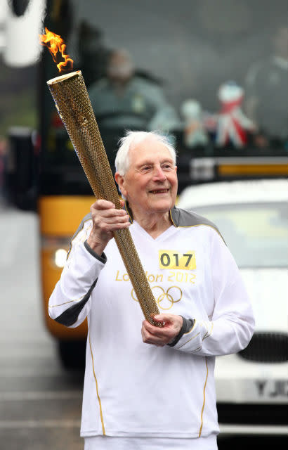 William Whittaker carries the Olympic Flame on the Torch Relay leg between St Ives and Huntingdon.