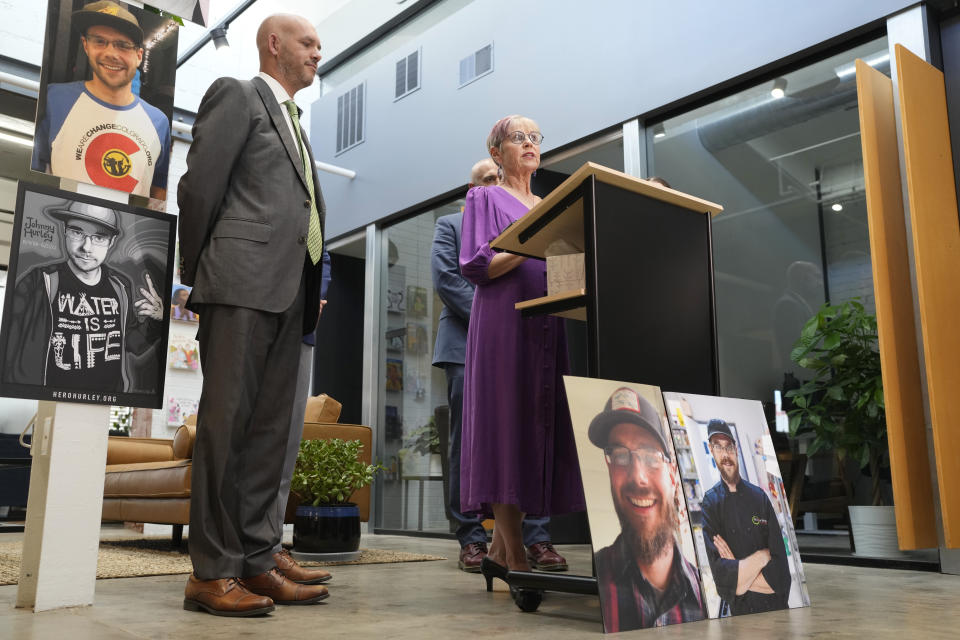 Kathleen Boleyn, right, mother of man who was fatally shot by a police officer from the Arvada, Colo., Police Department in June 2021, talks about the $2.8-million settlement reached with the northwest Denver suburban city Thursday, Sept. 28, 2023, in Denver. Boleyn's son, Johnny Hurley, was shot after he had killed an active shooter who had killed an Arvada officer in the city's Olde Town area on June 21, 2021. Attorney Matthew J. Cron, left, looks on during the news conference. (AP Photo/David Zalubowski)