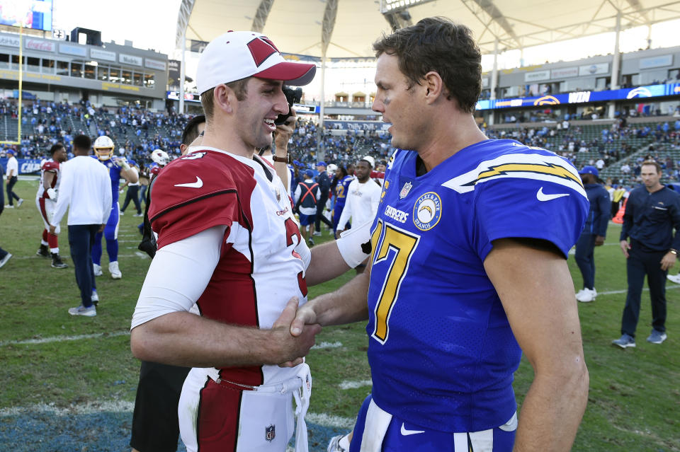Los Angeles Chargers quarterback Philip Rivers, right, shakes hands with Arizona Cardinals quarterback Josh Rosen at the end of an NFL football game Sunday, Nov. 25, 2018, in Carson, Calif. (AP Photo/Kelvin Kuo)