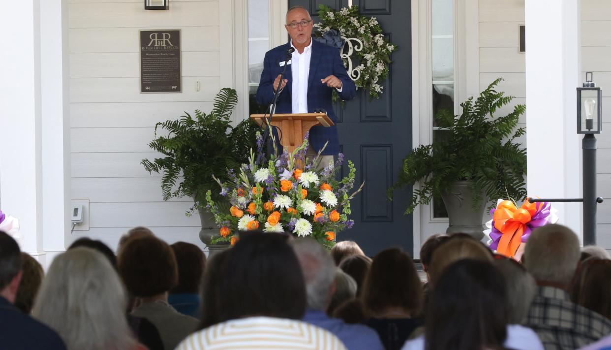 Keith Henry speaks from the front porch of the Westmoreland Family Home at River Hill Refuge during their Dedication Ceremony held Saturday, April 27, 2024.