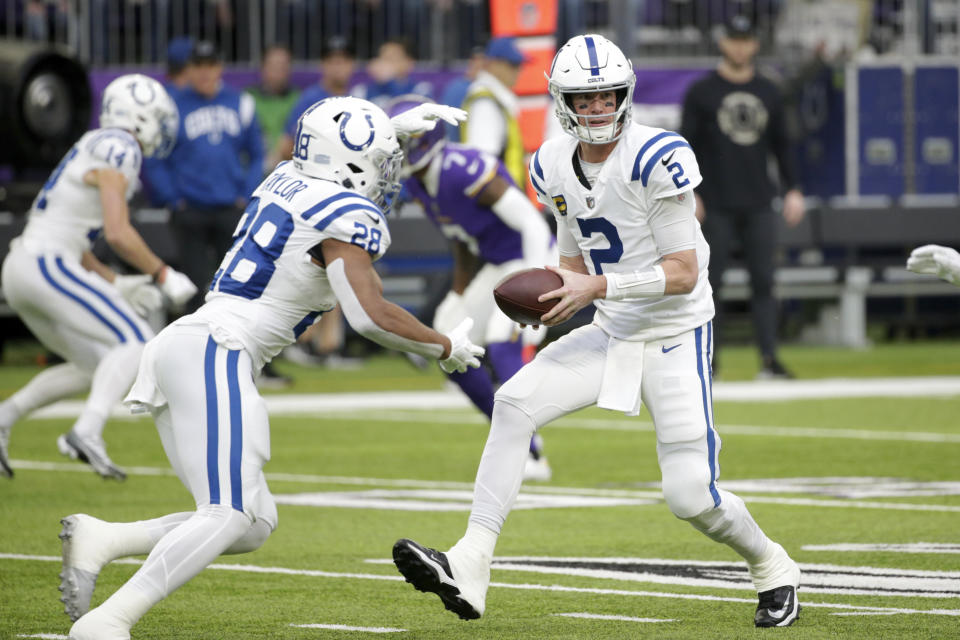 Indianapolis Colts quarterback Matt Ryan (2) looks to hand the ball off to running back Jonathan Taylor (28) during the first half of an NFL football game against the Minnesota Vikings, Saturday, Dec. 17, 2022, in Minneapolis. (AP Photo/Andy Clayton-King)