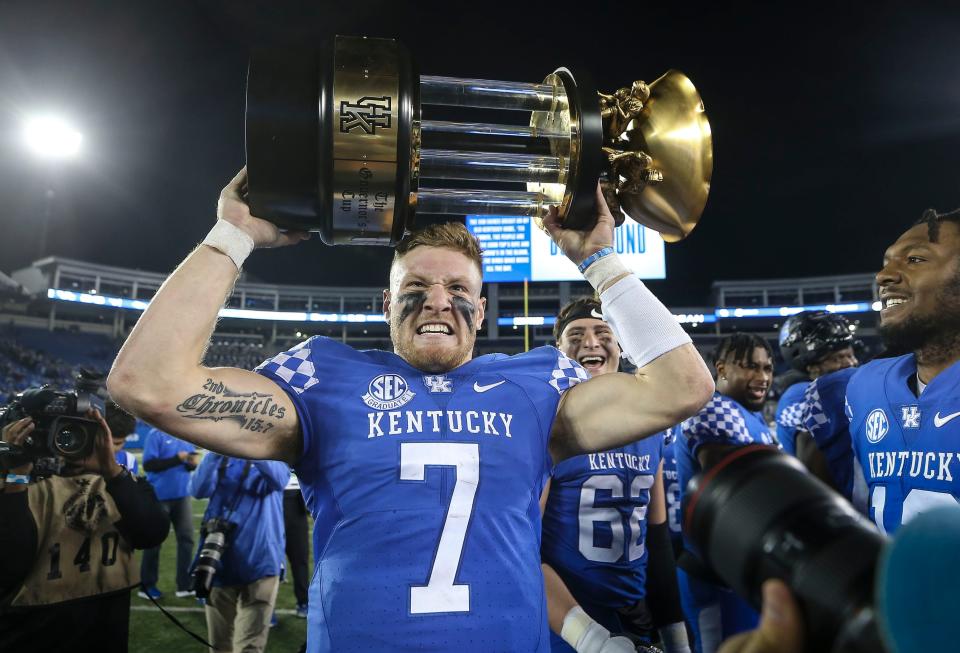 Kentucky's Will Levis grimaces while hoisting the 2022 Governor's Cup trophy after the Wildcats defeated Louisville. Nov. 26, 2022

Louisville Vs Kentucky 2022 Football