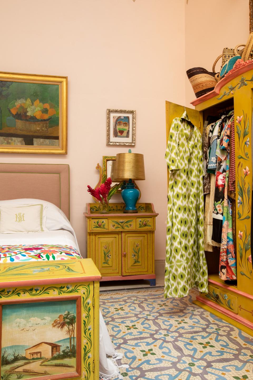 In a guest bedroom, the armoire is an antique piece found in Mérida that Skouras had painted to match the circa-1900 bedside table and cabinet from Sicily. The painting is by Neil Stokoe. The original floor tile, known locally as pasta tile, is “highly unusual and cannot be reproduced,” notes Skouras.