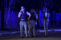 South Carolina state troopers gather on Hoffmeyer Road near the Vintage Place neighborhood where several law enforcement officers were shot, one fatally, Wednesday, Oct. 3, 2018, in Florence, S.C. (AP Photo/Sean Rayford)