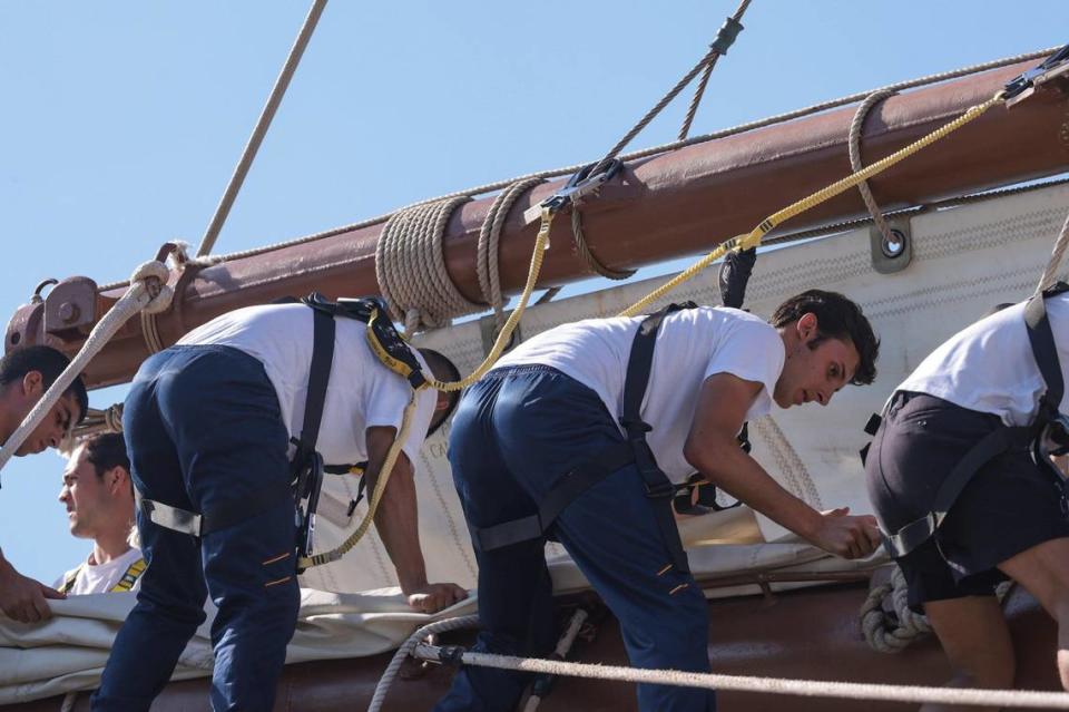 Sailors roll the sails of the Juan Sebastián de Elcano as it docks at Maurice A. Ferré Park. This cruise is the last of the three that commemorate the V Centenary of the First Circumnavigation.