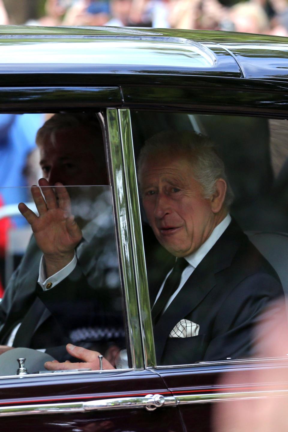 Britain's King Charles III waves to the crowds after leaving Clarence House in central London Wednesday Sept. 14, 2022, ahead of the ceremonial procession of the coffin of Queen Elizabeth II.