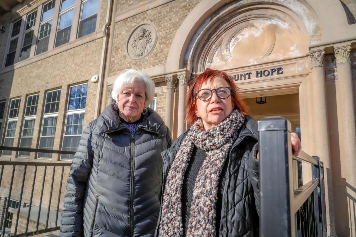 Judith Glynn, left, and Stephanie Isenberg stand outside the Chapel Hill East condo development in Providence, which they say has been plagued with problems.