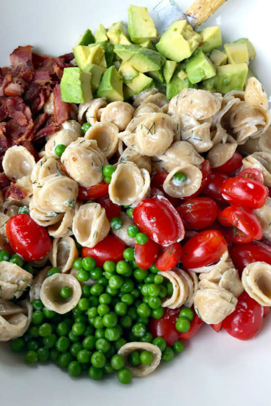 <p>Reluctant Entertainer</p><p>Fresh avocado, English peas and a creamy dressing make this pasta salad a little sophisticated.</p><p><strong>Get the recipe:</strong> <strong><a href="http://reluctantentertainer.com/summer-avocado-pasta-salad/" rel="nofollow noopener" target="_blank" data-ylk="slk:Summer Avocado Pasta Salad;elm:context_link;itc:0;sec:content-canvas" class="link ">Summer Avocado Pasta Salad</a></strong></p>