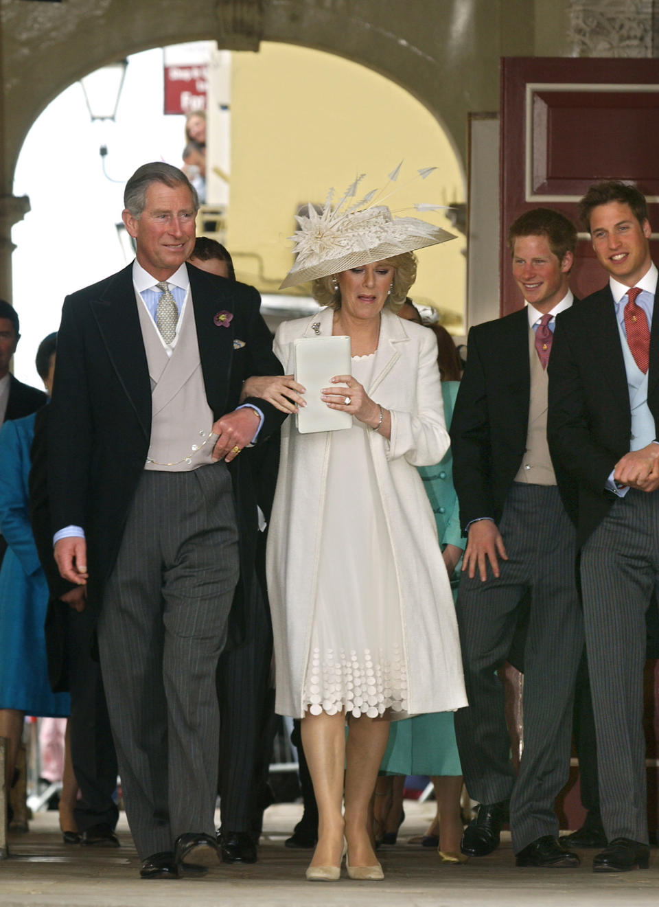 Prince Charles and his wife the Duchess of Cornwall, formerly Camilla Parker Bowles are followed by Princes Harry (2nd R) and William (R) as they leave the guildhall where the Royal wedding was celebrated, 09 April, 2005, in Windsor.  Prince Charles and his longtime sweetheart Camilla Parker Bowles married today after two months of muddled preparations and a lifetime of waiting. (Photo credit should read ERIC FEFERBERG/AFP via Getty Images)