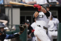 Chicago White Sox's Andrew Benintendi (23) hits a two-run single during the eighth inning of a baseball game against the Tampa Bay Rays in Chicago, Sunday, April 28, 2024. (AP Photo/Nam Y. Huh)