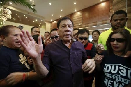 Rodrigo Duterte (C), a seven-term Philippine mayor, walks with his supporters during proclamation ceremony as a presidential candidate held at a hotel in Manila November 30, 2015 REUTERS/Romeo Ranoco/File Photo