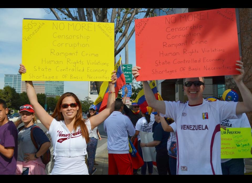 Diana Mendoza and Dan Devries demonstrate on the corner of Wilshire Boulevard and Veteran Avenue. Diana moved to the United States 10 years ago to study. She and Dan have visited her family Venezuela three times in the past 4 years.