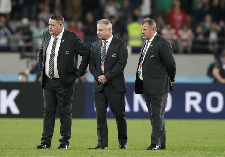 New Zealand coach Steve Hansen, left, stands with selector Grant Fox, centre and his assistant Ian Foster following the Rugby World Cup quarterfinal match at Tokyo Stadium between New Zealand and Ireland in Tokyo, Japan, Saturday, Oct. 19, 2019. (AP Photo/Mark Baker)