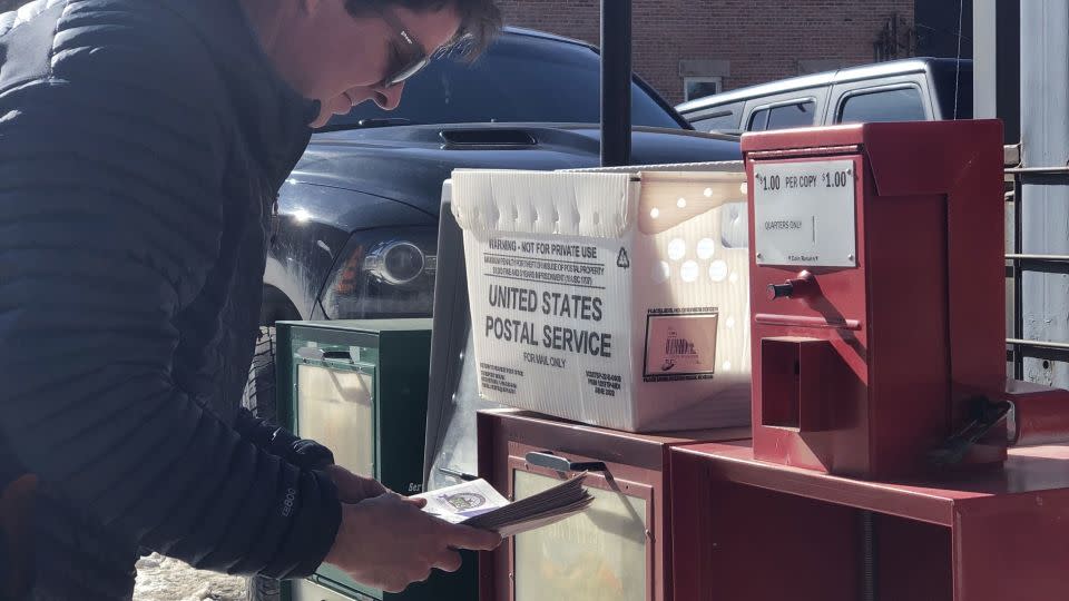 Ouray County Plaindealer co-publisher Mike Wiggins stocks newspaper racks with reprinted copies. - Ouray County Plaindealer