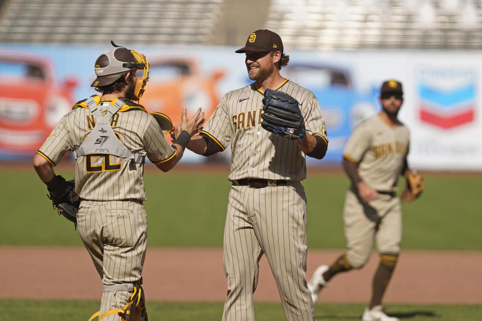 San Diego Padres relief pitcher Trevor Rosenthal, front right, is greeted by catcher Austin Nola at the end of a baseball game against the San Francisco Giants, Sunday, Sept. 27, 2020, in San Francisco. (AP Photo/Eric Risberg)