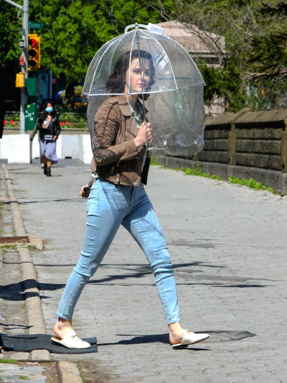 <p>Even when she's not in costume, Brosnahan still looks chic with her umbrella on her way to set. </p>