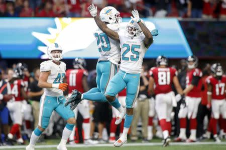 Oct 15, 2017; Atlanta, GA, USA; Miami Dolphins free safety Reshad Jones (20) celebrates with cornerback Xavien Howard (25) after an interception against the Atlanta Falcons in the fourth quarter at Mercedes-Benz Stadium. Mandatory Credit: Brett Davis-USA TODAY Sports