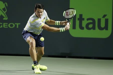 Mar 28, 2018; Key Biscayne, FL, USA; Milos Raonic of Canada hits a backhand against Juan Martin del Potro of Argentina (not pictured) on day nine at the Miami Open at Tennis Center at Crandon Park. Mandatory Credit: Geoff Burke-USA TODAY Sports