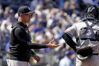 New York Yankees manager Aaron Boone walks to the mound to make a pitching change during the seventh inning of a baseball game against the Kansas City Royals Sunday, May 1, 2022, in Kansas City, Mo. (AP Photo/Charlie Riedel)