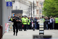 <p>Crowds of people wait outside after police avacuated the Arndale Centre on May 23, 2017 in Manchester, England. (Christopher Furlong/Getty Images) </p>