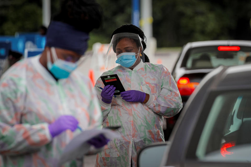 Medical technicians work at a Drive-Thru coronavirus disease (COVID-19) testing facility at the Regeneron Pharmaceuticals company's Westchester campus in Tarrytown, New York, U.S. September 17, 2020. Picture taken September 17, 2020. REUTERS/Brendan McDermid