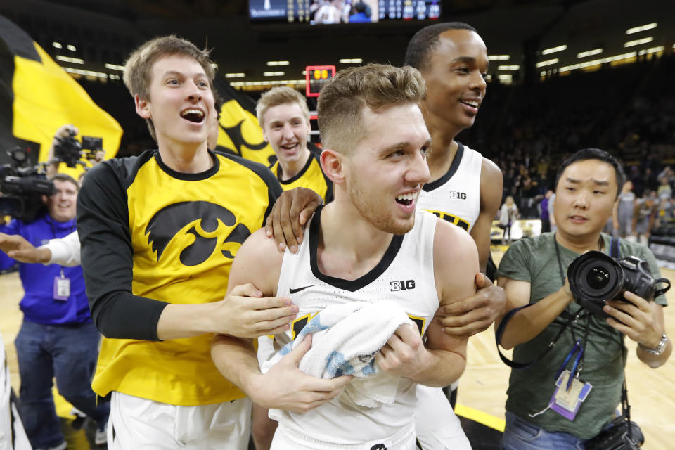 Iowa guard Jordan Bohannon, center, celebrates with teammates after hitting a three-point shot at the end of the game to beat Northwestern on Feb. 10, 2019, in Iowa City, Iowa. (AP)