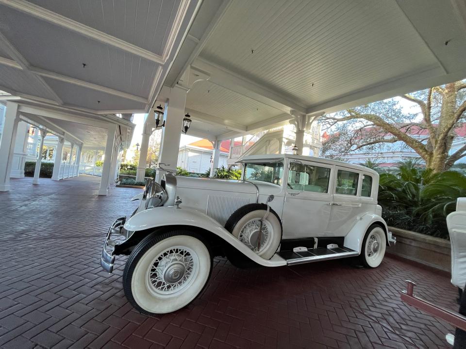 decorative old timey white cars parked in front of the grand floridian resort