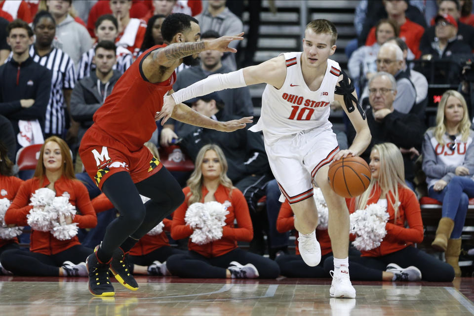 Ohio State's Justin Ahrens, right, controls the ball as Maryland's Eric Ayala defends during the first half of an NCAA college basketball game Sunday, Feb. 23, 2020, in Columbus, Ohio. (AP Photo/Jay LaPrete)