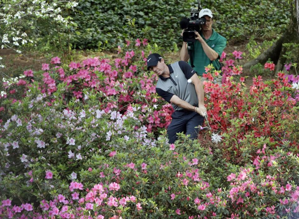 Rory McIlroy, of Northern Ireland, hits out of the azaleas to the 13th green during the second round of the Masters golf tournament Friday, April 11, 2014, in Augusta, Ga. (AP Photo/David J. Phillip)