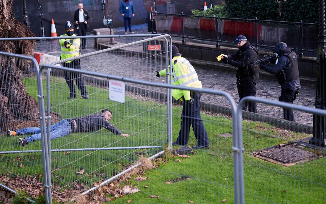 Armed Police detain a man in the grounds of the Palace of Westminster  - Tom Bowles / Story Picture Agency