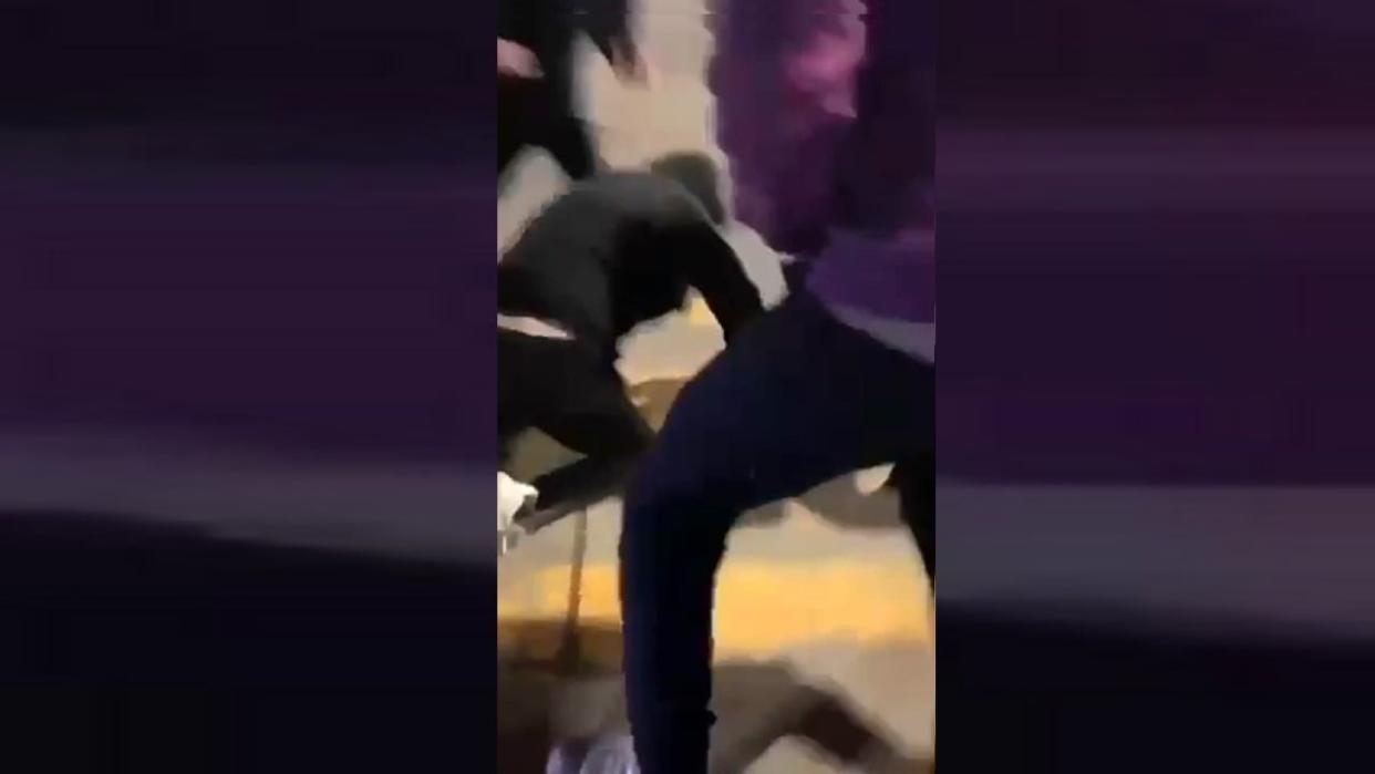 A screen capture from a Snapchat video shows a 16-year-old autistic teen on his knees as he is punched and kicked by a group of other teens at the Devonshire Mall in Windsor on March 9, 2024. (Snapchat - image credit)