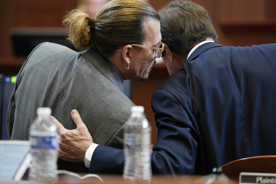 Actor Johnny Depp talks to his attorney in the courtroom at the Fairfax County Circuit Court in Fairfax, Va., Wednesday May 4, 2022. Depp sued his ex-wife Amber Heard for libel in Fairfax County Circuit Court after she wrote an op-ed piece in The Washington Post in 2018 referring to herself as a "public figure representing domestic abuse." (Elizabeth Frantz/Pool Photo via AP)