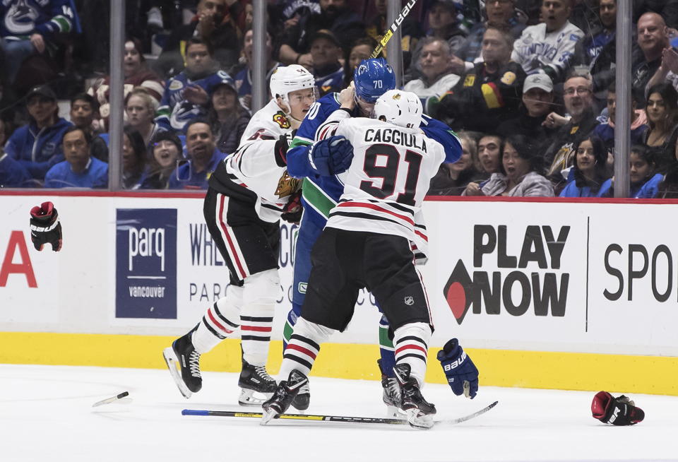 Vancouver Canucks' Tanner Pearson (70) and Chicago Blackhawks' Drake Caggiula (91) drop their gloves as they fight during the second period of an NHL hockey game Wednesday, Feb. 12, 2020, in Vancouver, British Columbia. (Darryl Dyck/The Canadian Press via AP)
