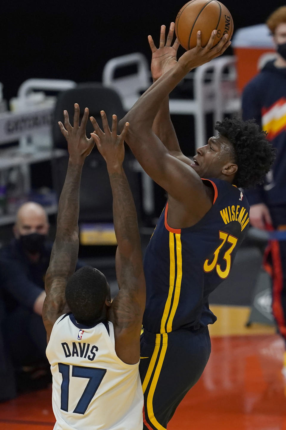 Golden State Warriors center James Wiseman (33) shoots over Minnesota Timberwolves forward Ed Davis (17) during the first half of an NBA basketball game in San Francisco, Monday, Jan. 25, 2021. (AP Photo/Jeff Chiu)