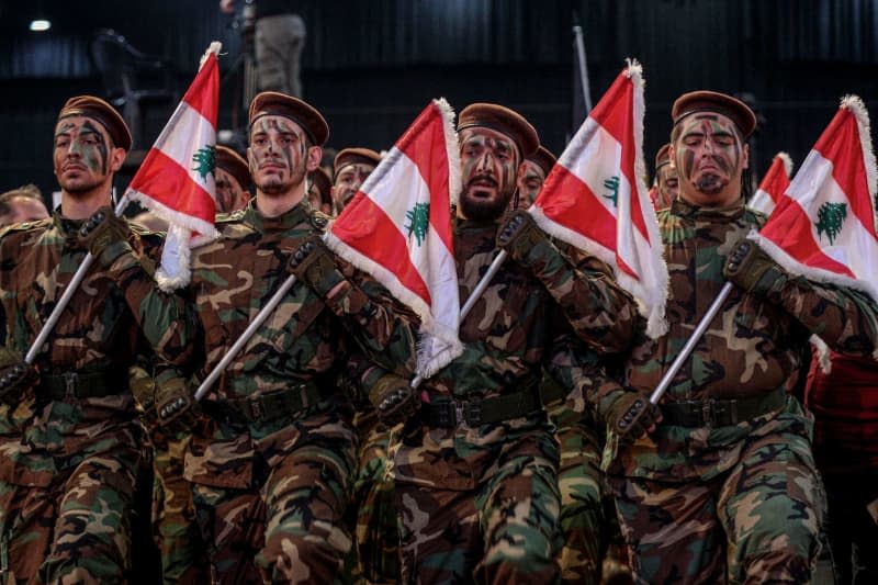 Pro-Iranian Hezbollah militants parade during a ceremony to mark al-Quds International Day in Beirut's southern suburb. Marwan Naamani/dpa