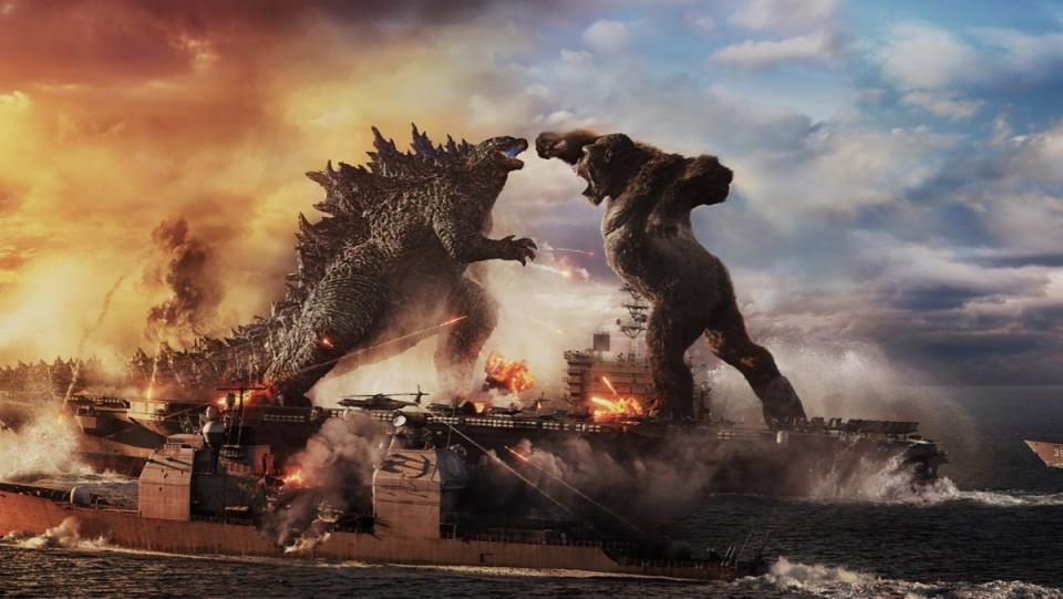 King Kong aims a punch at Godzilla atop a naval fleet in a scene from Godzilla vs. Kong.