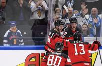 Team of Canada celebrates a overtime goal scored by Drake Batherson, during the Hockey World Championship quarterfinal match between Sweden and Canada in Tampere, Finland, Thursday, May 26, 2022. (Vesa Moilanen/Lehtikuva via AP)
