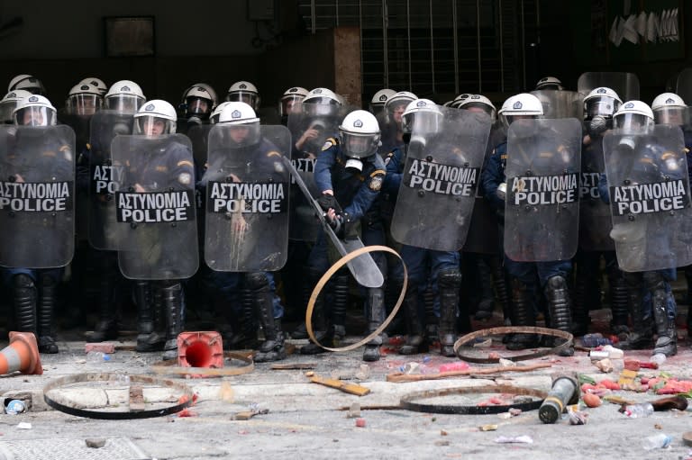 Police block the way as farmers protest in front of the agriculture ministry in Athens during a demonstration against pension reforms on February 12, 2016