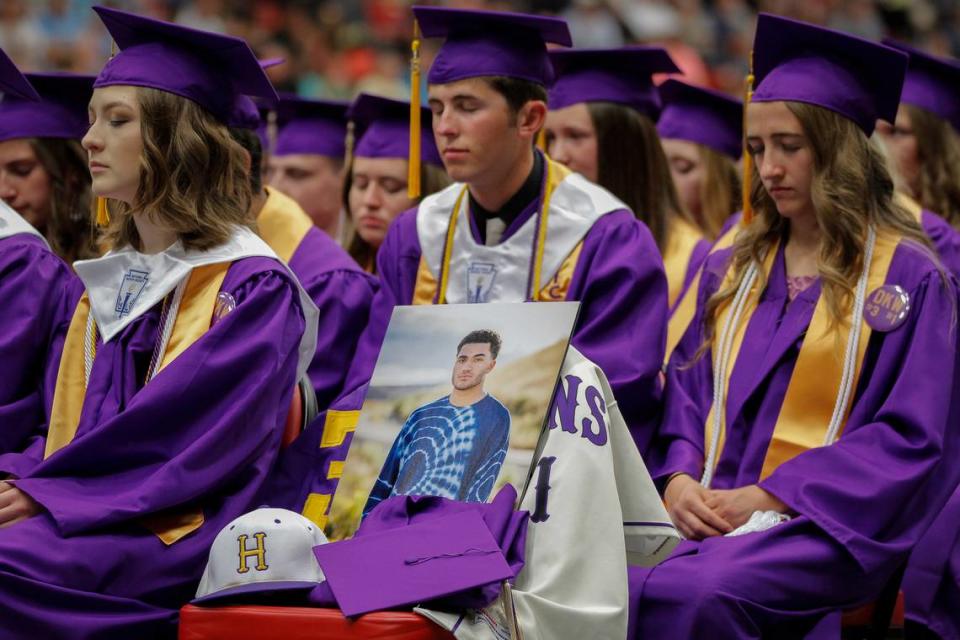 Hanford High School students and staff take a moment of silence to honor their classmate Dmetri Kennedy-Woody during the 2018 commencement ceremony at the Toyota Center.