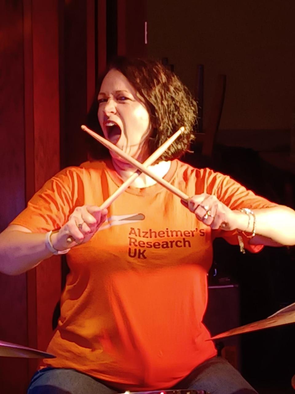 Woman holding drumming sticks in her hands