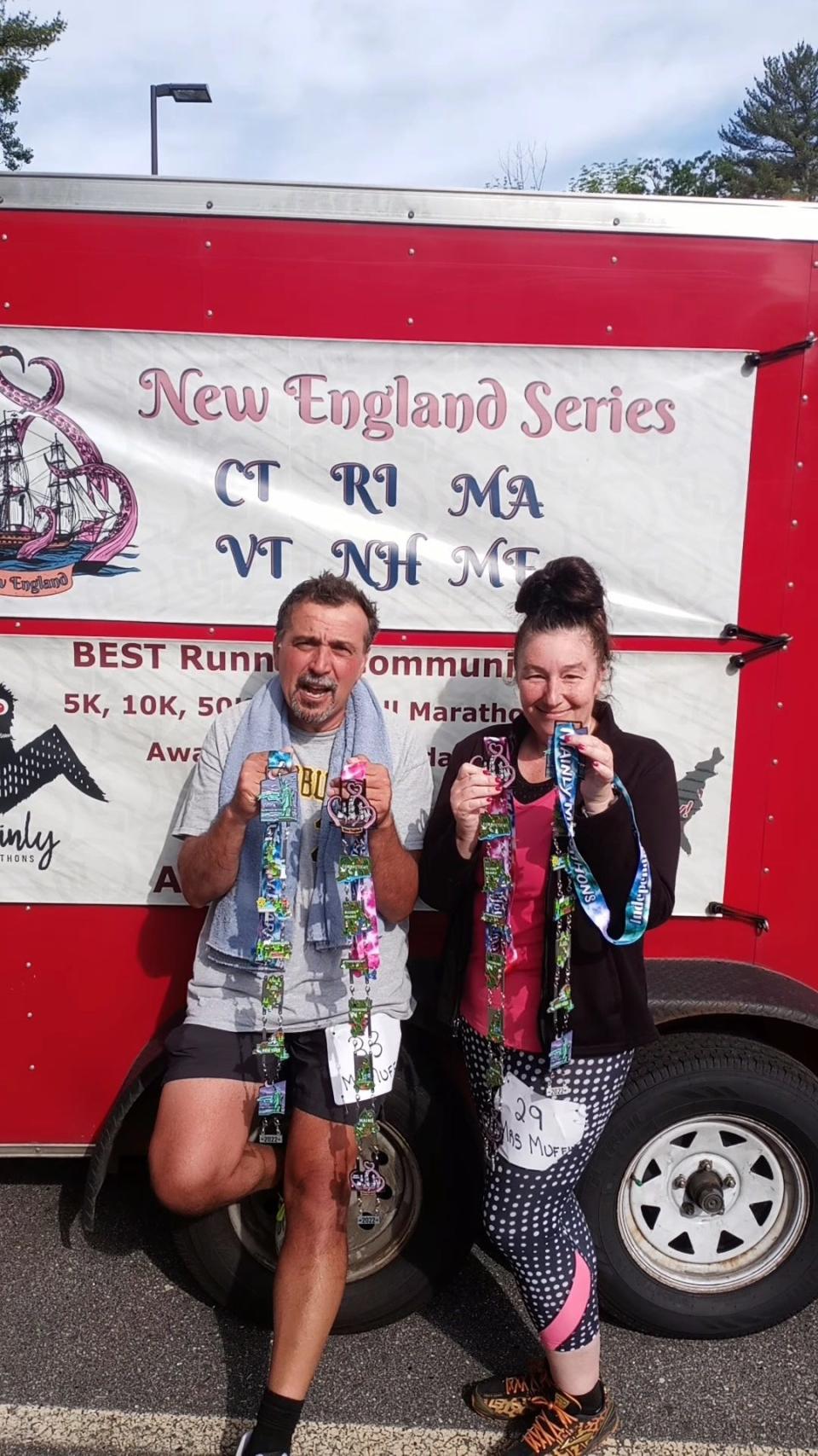 Ann Sylvia and Robert Cordeiro of New Bedford stand at the finish line of a half marathon in Sanford, Maine, on Saturday, June 11. It was the couple's last stop on their record-setting run of 11 half marathons in 11 different states, and completed in as many days. Now, they await a response from Guinness World Records to their submission to have the achievement recognized.